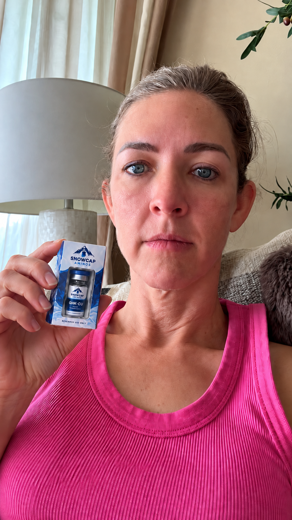 Woman holding a boxed Snowcap GHK-Cu vial