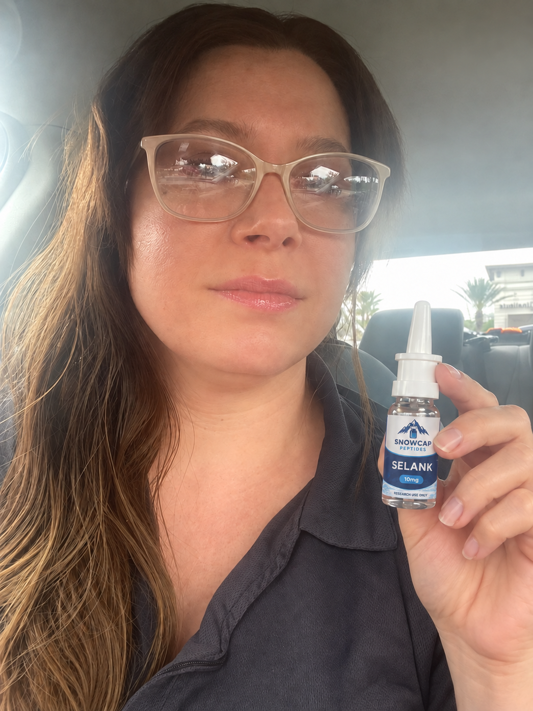 Woman holding a Snowcap Selank spray