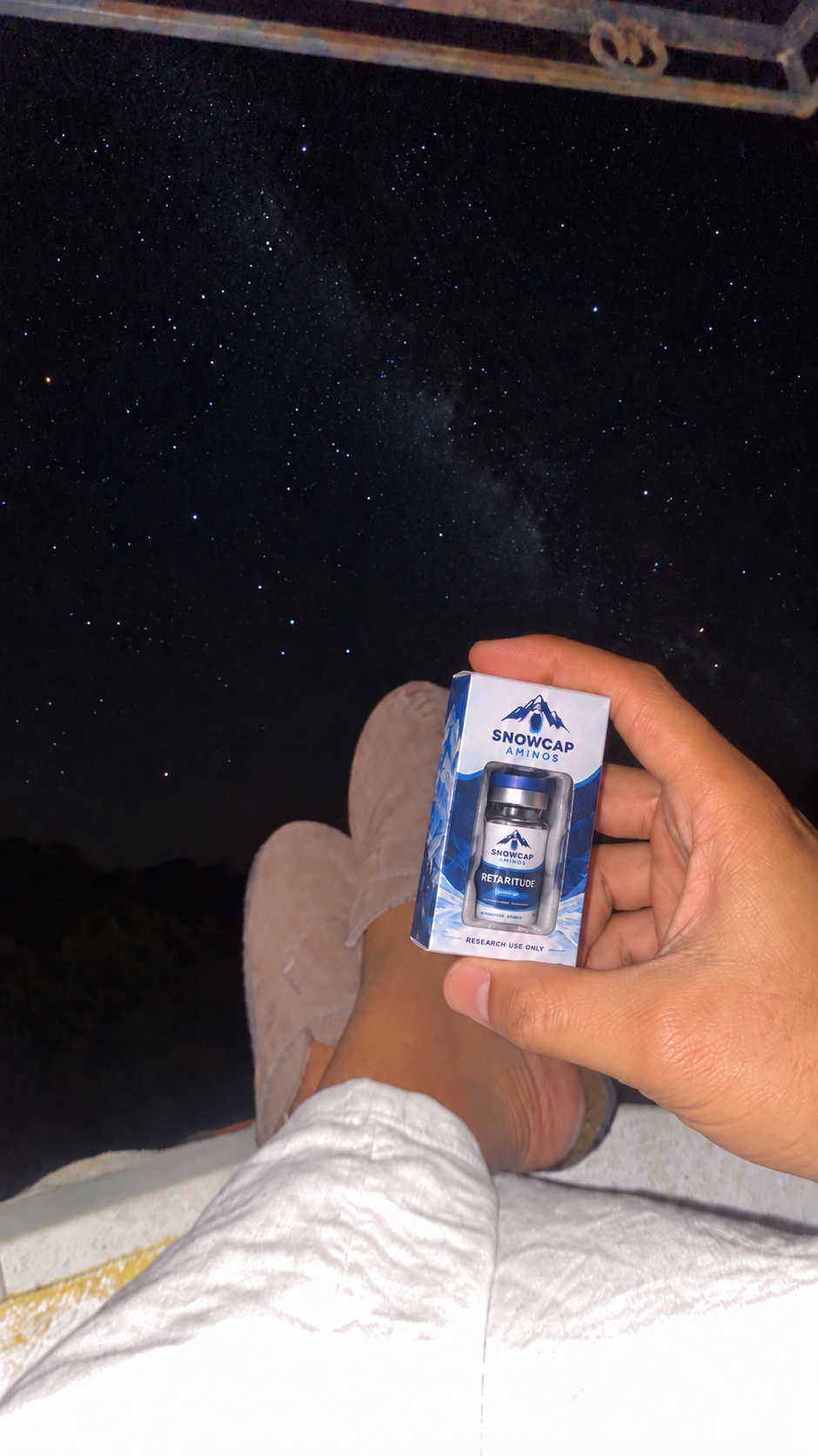 Hand holding a boxed Snowcap Retatrutide vial