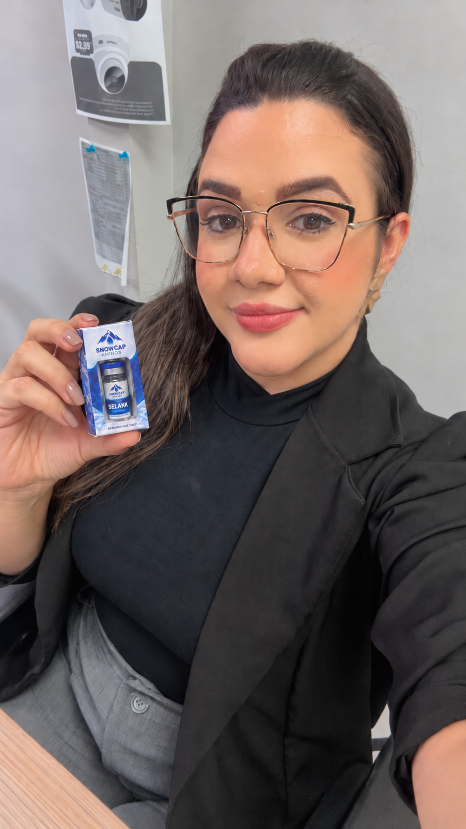 Woman holding a boxed Snowcap Selank vial
